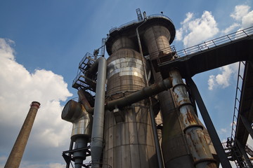 Exterior of old rusty structural concrete and steel industrail factory, abandon former ironworks.
