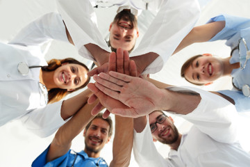 Obraz na płótnie Canvas bottom view.a team of doctors at the medical center clasped their hands together