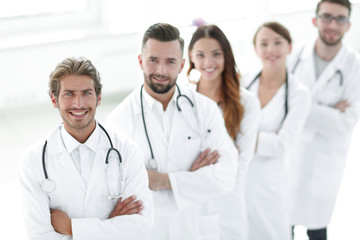 Fototapeta premium Portrait of medical team standing with arms crossed in hospital