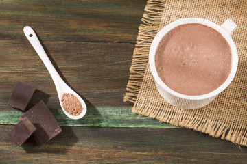 Cup of tasty hot chocolate on wooden background