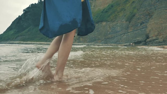 4 k beautifull young girl, mother walking and taking time with her cute little baby, among the Cantabrian coast, in the bay of Atlantic ocean at cloudy morning