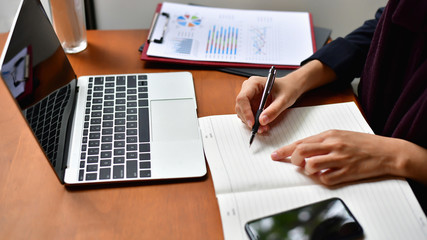 Business Concept.Young Asian businesswoman is working happily.Young businesswoman working in a cafe.Young businesswoman is relaxation in a coffee shop.