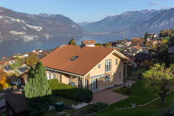 Fototapeta na wymiar Lake Thun and typical Switzerland village near town of Interlaken, canton of Bern