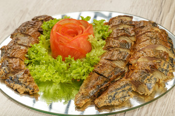 Sliced herring on a plate with herbs.