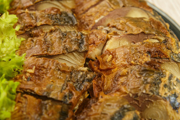 Sliced herring on a plate with herbs.