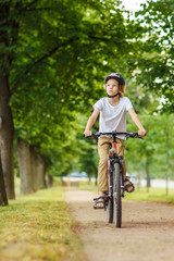 Fototapeta na wymiar Handsome boy on the bicycle, summer day