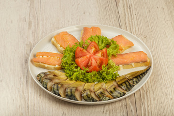 Sliced herring on a plate with herbs.