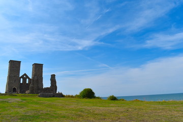 The imposing twin towers of the medieval church at Reculver, Herne Bay, Kent, England, August, 2018