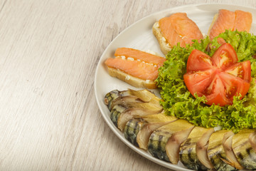 Sliced herring on a plate with herbs.