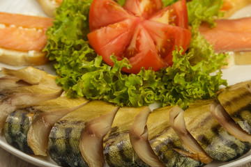 Sliced herring on a plate with herbs.