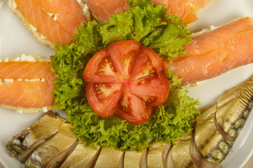 Sliced herring on a plate with herbs.