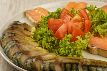 Sliced herring on a plate with herbs.