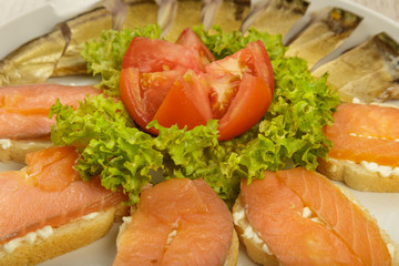 Sliced herring on a plate with herbs.