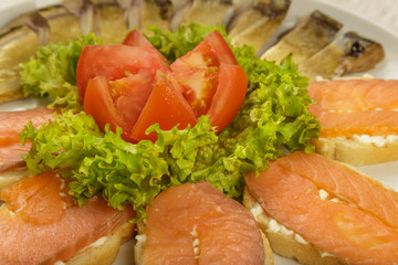 Sliced herring on a plate with herbs.