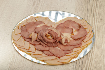 Fototapeta premium Sausage cuts of different varieties on a plate.