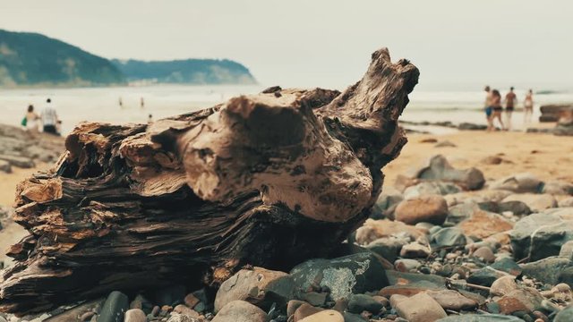 4 k Atlantic coast with rocks of differnt colour, orange sand and waves of ocean water at cloudy day, Cantabrian seaside