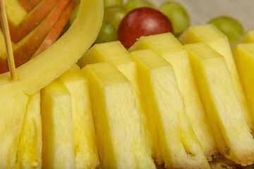 Very nice and artistically sliced fruits on a platter.