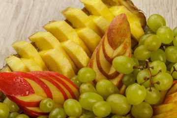 Very nice and artistically sliced fruits on a platter.