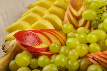 Very nice and artistically sliced fruits on a platter.