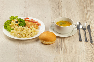 A lunch with a pasta chop with pasta and a roll.