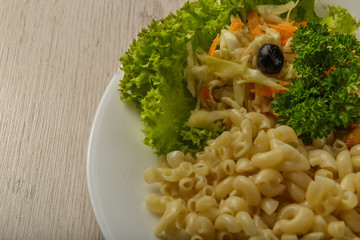 Pasta with a piece of grilled meat and salad.