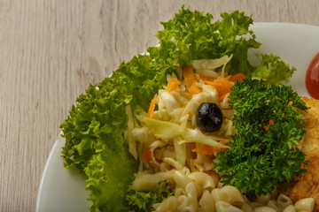 Pasta with a piece of grilled meat and salad.