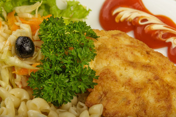 Pasta with a piece of grilled meat and salad.