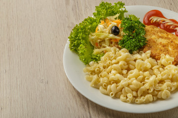Pasta with a piece of grilled meat and salad.