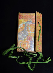 Small handmade notebook with green string, half opened