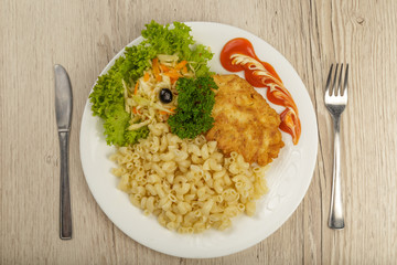 Pasta with a piece of grilled meat and salad.