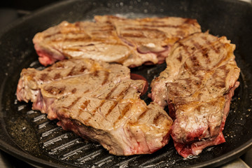 Three Chuck Steaks Turned on Grill