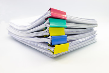 Stack of papers documents in archives files with paper clips on desk at offices, business concept.