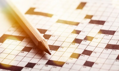 Crossword Puzzle and Pencil on background