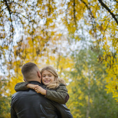 Fototapeta premium portrait of pretty little girl and young father walking in beautiful autumn park