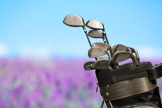 Different golf clubs on natural  background