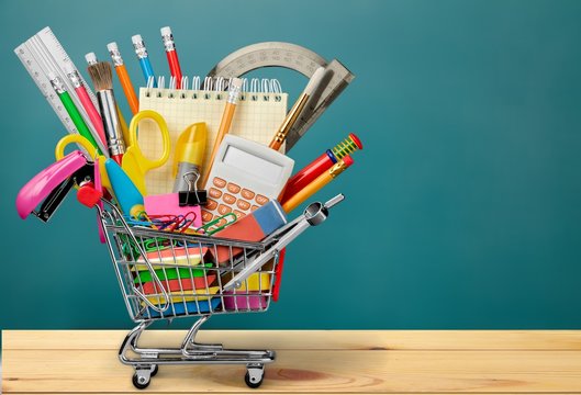 Premium Photo  Shopping carts with school supplies isolated on a