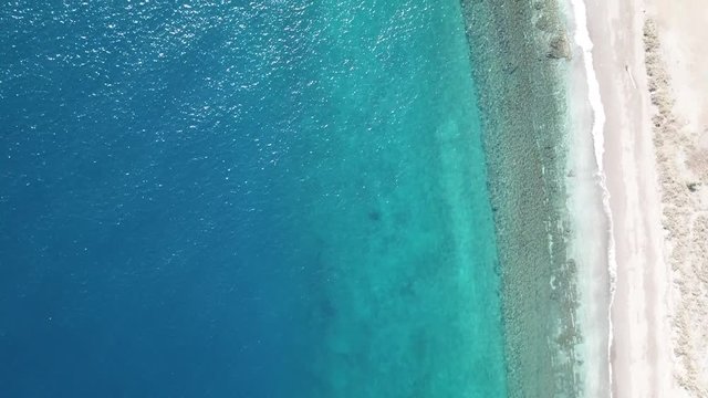 Aerial drone footage of desert beach and blue sea 