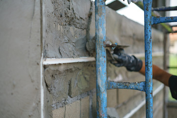 Worker labor building wall and UPVC groove line with plaster cement