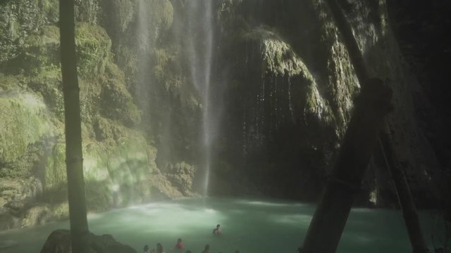 People bathing in and enjoying Tumalog falls.