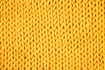 Bright yellow cotton knitting on knitting needles, needlework.