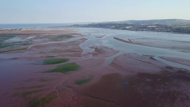 Aerial pan over Lympstone, England. Tide out. Beautiful landscape.
