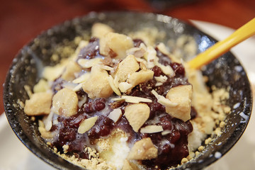 patbingsu shaved ice with sweetened red beans and syrup on bowl