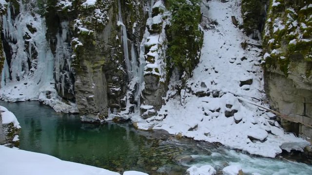 Flowing stream in a canyon during winter.