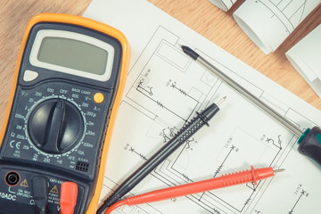 Electrical drawings, multimeter for measurement in installation and screwdriver for use in engineer...