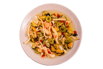 Ceramic plate with the different sea food and olives isolated on white background
