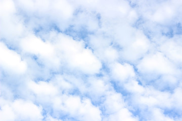 White fluffy cumulus clouds, blue sky