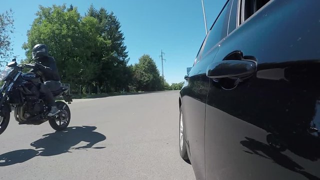 slomotion wheelie with a motorcycle filmed by a car