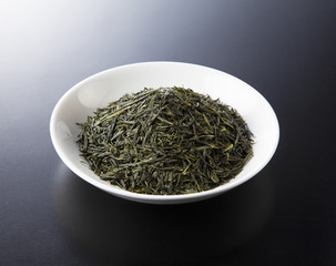 green tea leaves isolated on black background