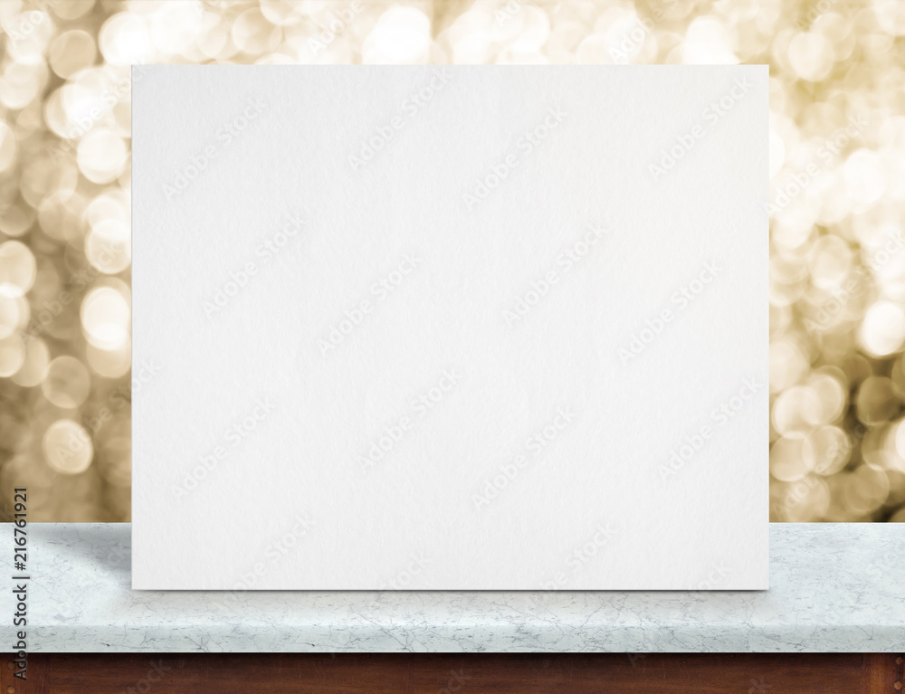 Poster blank white paper poster on white marble table top and sparkling gold bokeh light,mock up to display
