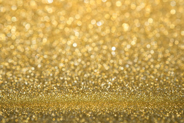 Abstract gold sparkling glitter wall and floor perspective background studio with blur bokeh.luxury holiday backdrop mock up for display of product.holiday festive greeting card.